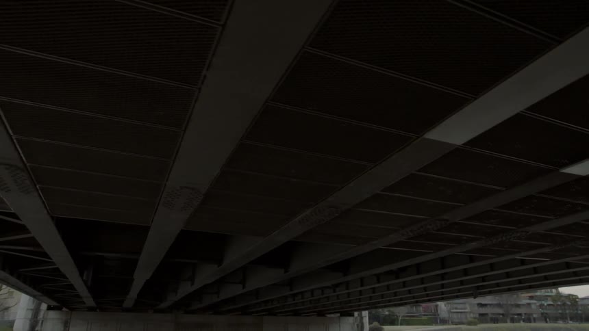 A river flows under a city bridge