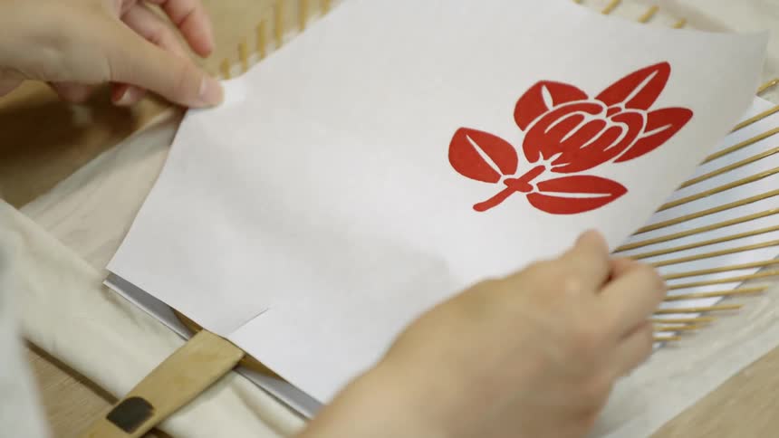 A person is laying paper creating a fan