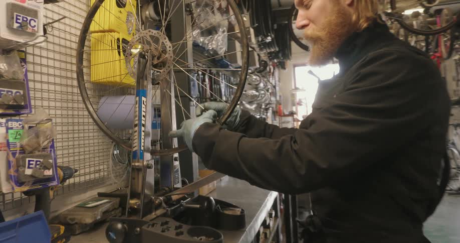 Mechanic working on a bicycle wheel