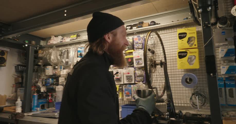 Two men drinking coffee in a mechanics workshop