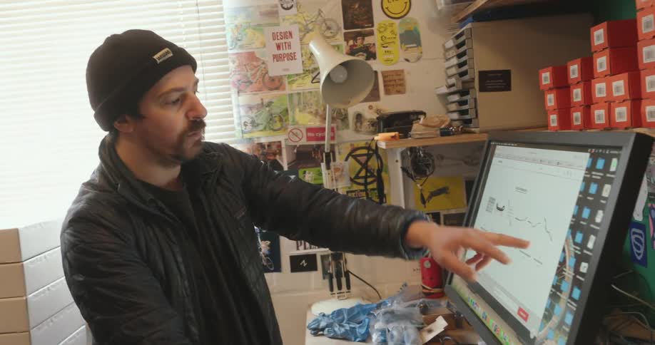 Two men look at information on the computer screen