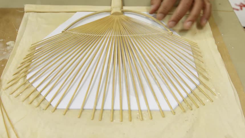 Person assembles paper fans