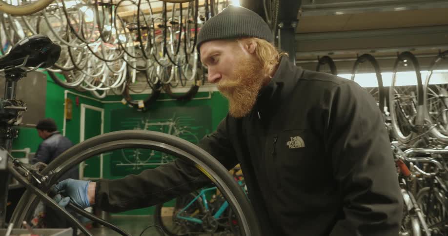 Two men working in a bicycle workshop