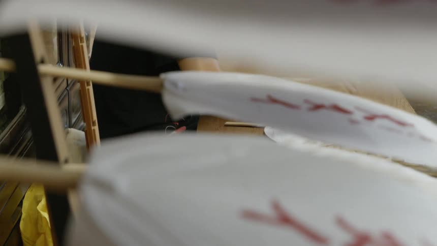 Person assembles a paper fan