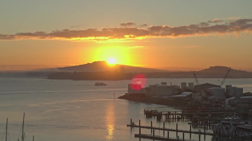 The sun is rising on the harbor