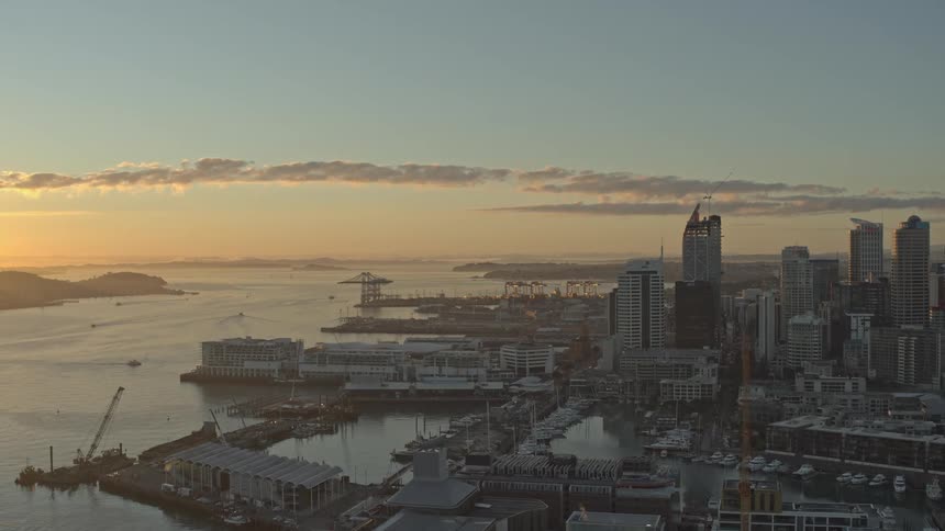 The sun is rising on the coastal city
