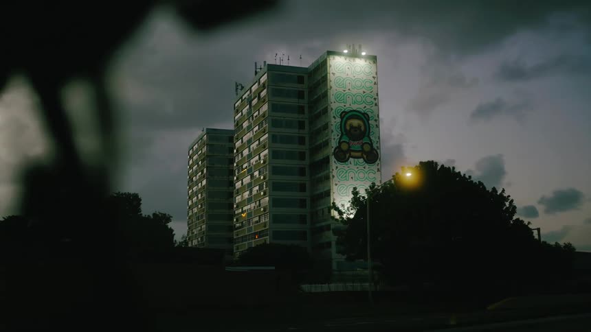 A large graffiti mural is on the side of the apartment building