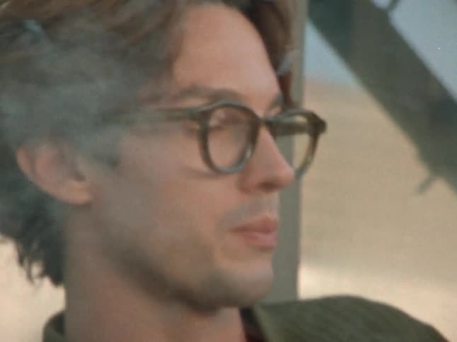 A man is smoking a cigarette outside