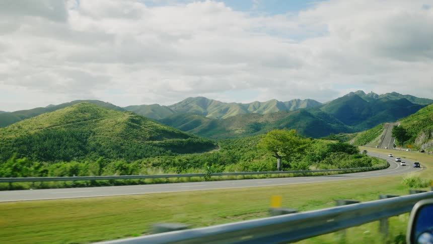 Traffic runs on the highway through the mountains