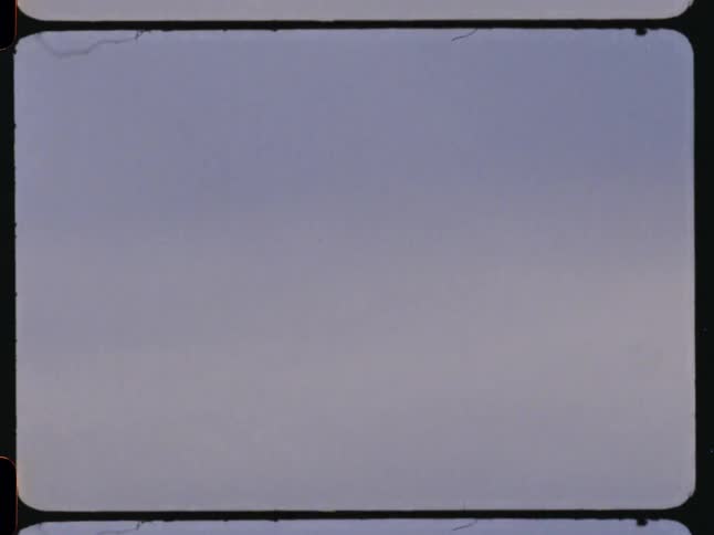 A cityscape is shown in winter under a cloudy gray sky