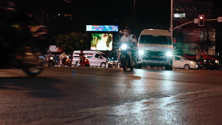 Cars are driving on a busy road during the night time