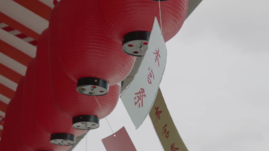 Tags blowing in the wind hanging off paper lanterns