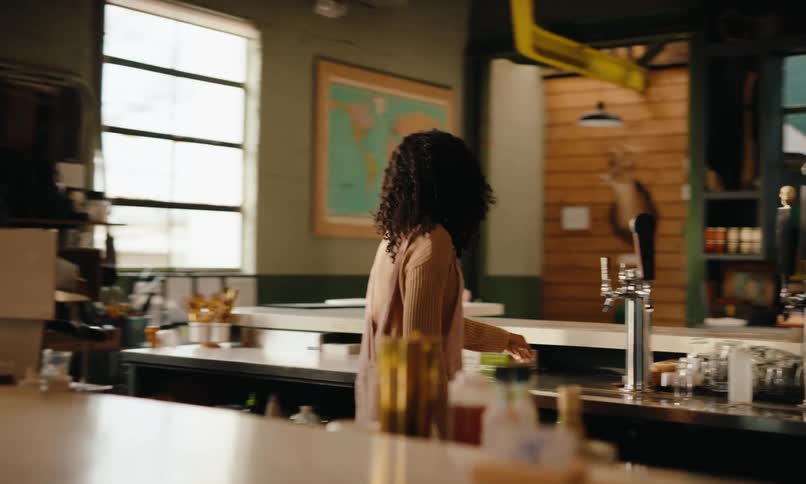 Man and woman working at the counter of a coffee shop