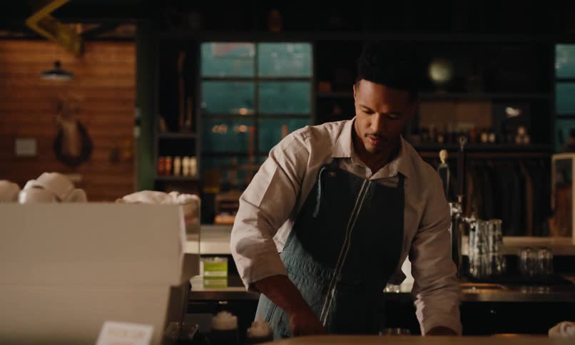 Man in apron working in a coffee shop