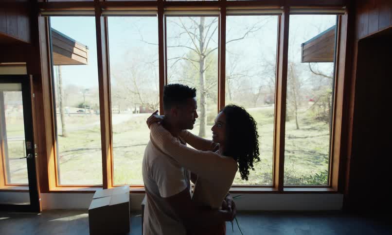 A couple are dancing at home