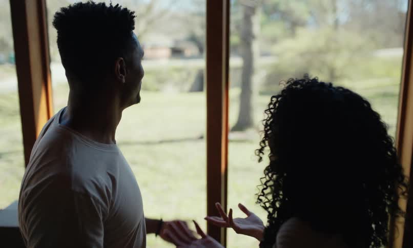 Couple hugging and talking inside the house