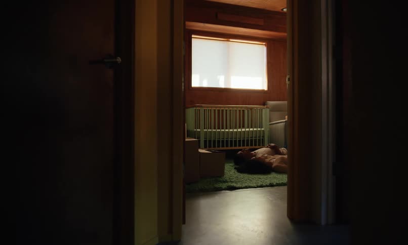 Couple lies down on the floor of the baby room while unpacking during the daytime