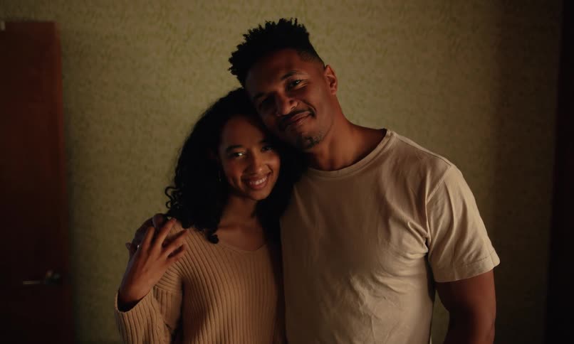 A man and woman are hugging and smiling