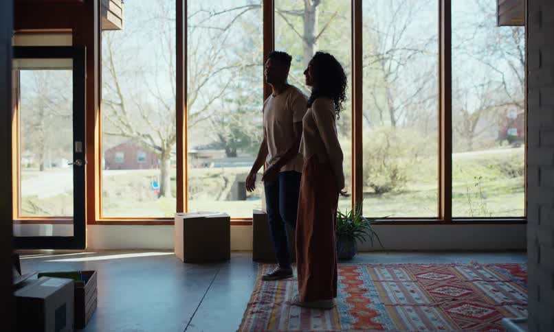 A couple plan where to put things as they move in