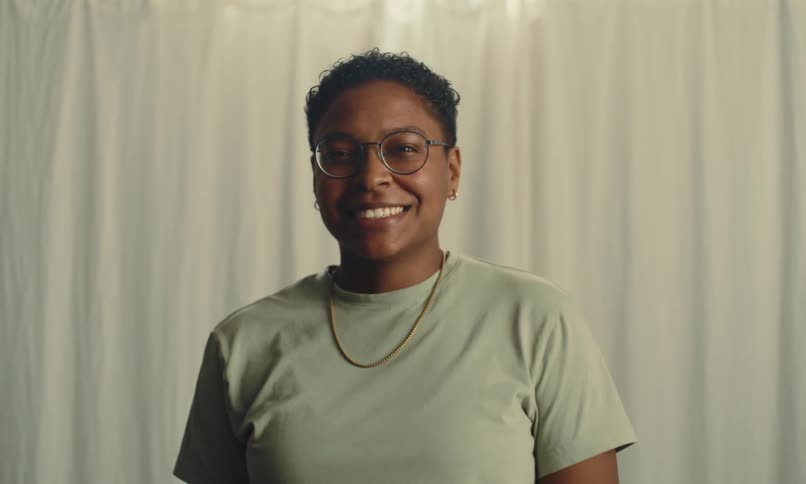 A woman gives a big smile