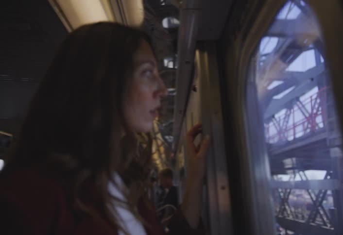 A footage of a lady standing in a train