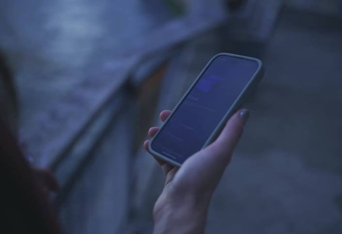 Pair of womans hands interacting with a smartphone