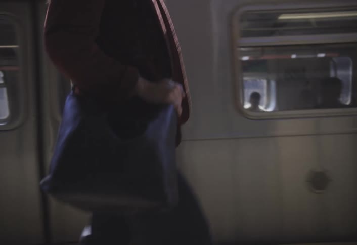A woman is walking on the trian platform