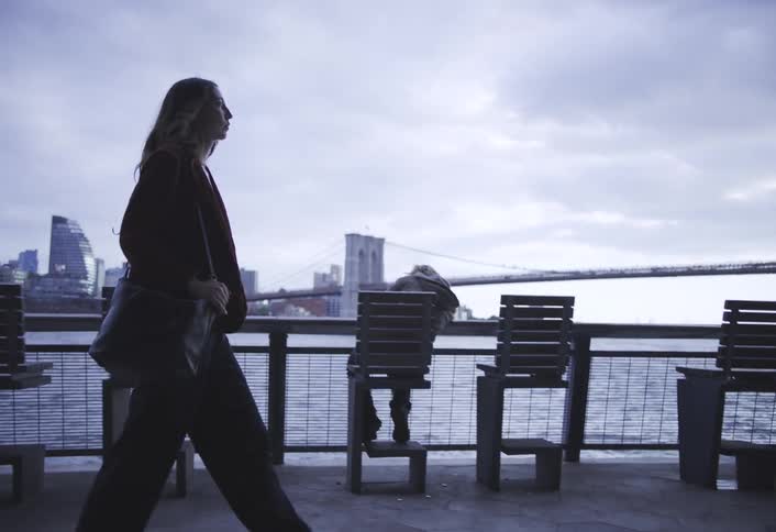 A footage of a lady walking by the waterfront