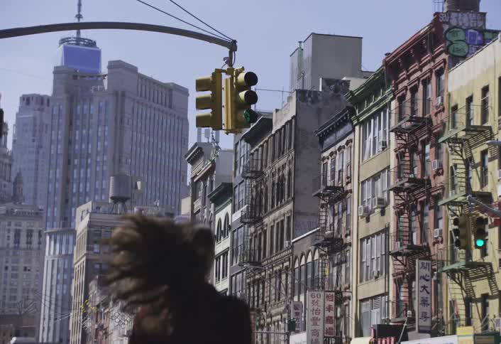 A woman runs down the sidewalk in the city
