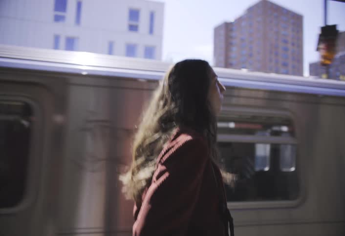 A footage of a lady walking on beside the rail