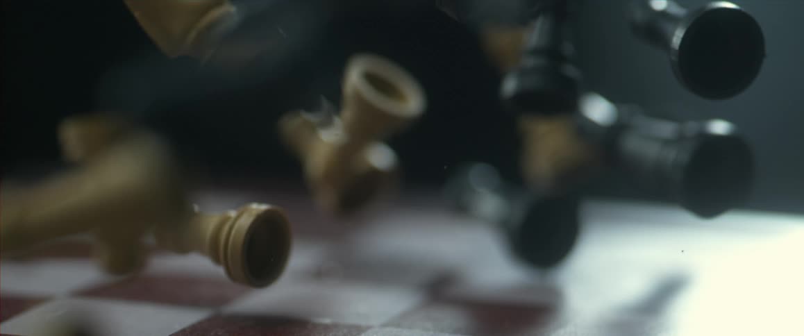 Chess pieces falling onto a chessboard