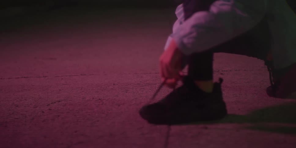 Runner taking a deep breath and tying her shoelaces