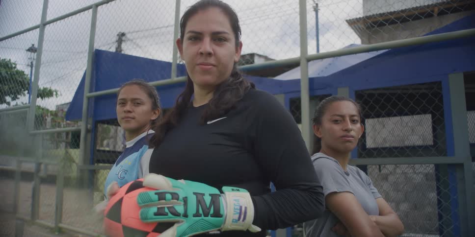 Team of three female soccer players standing with their arms crossed