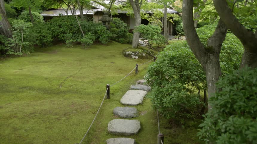 The path is lined with large cobble stones leading to a house