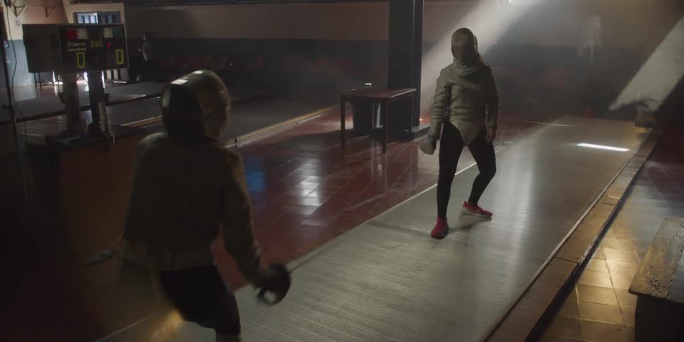 Two women practicing fencing