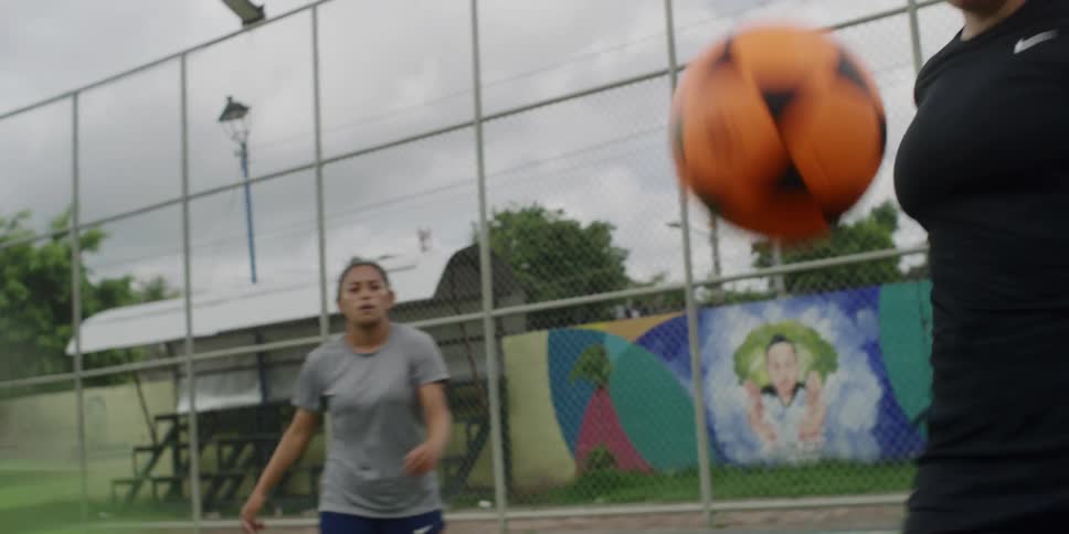 Three women juggling in an outdoor field