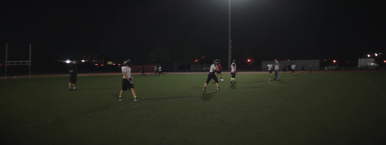 American football team on an outdoor field at night
