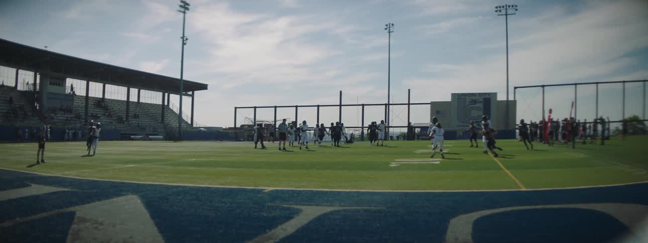 Two american football teams facing off on an outdoor field