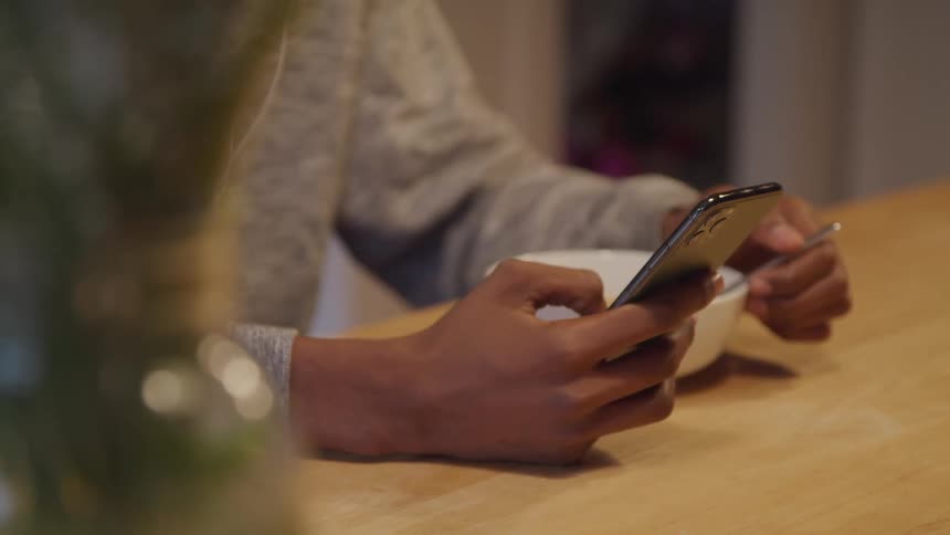 Persons hand interacting with an iphone