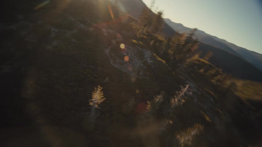 A woman running outdoors surrounded by trees and mountains