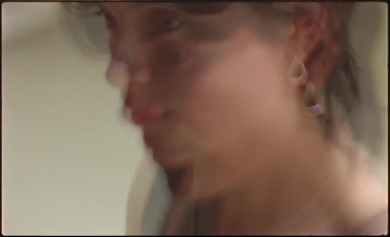 Moving views of a young woman modeling a silver necklace and earrings