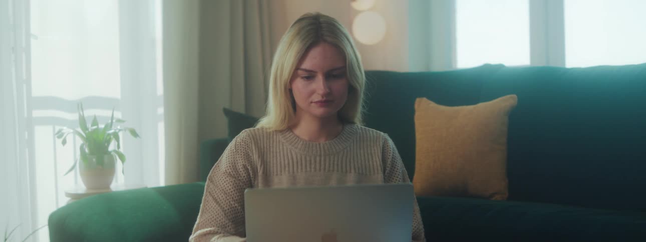 A woman is using her laptop at home
