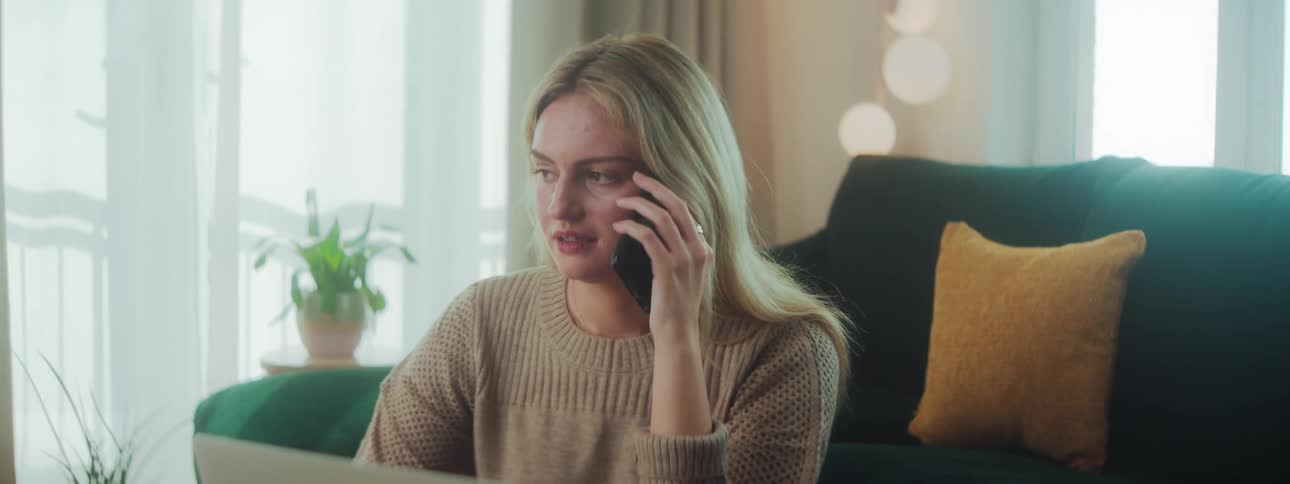 A woman is taking notes while talking