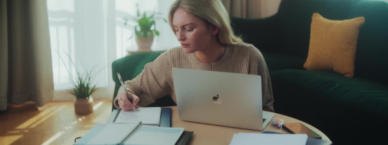 Woman sitting in front of a laptop and interacting with a document