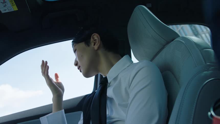 A close up clip of a lady sitting in a car