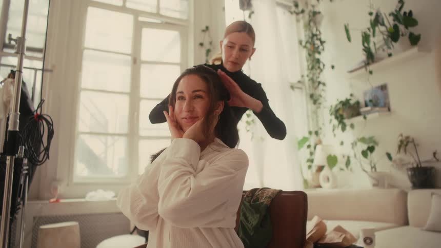 A footage of a person hairdressing a lady