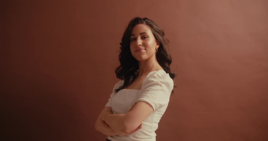 A powerful lady crossing her arms posing in the photo studio