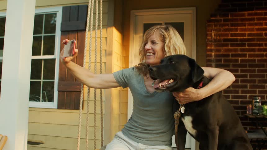 A woman is taking a selfie with her dog