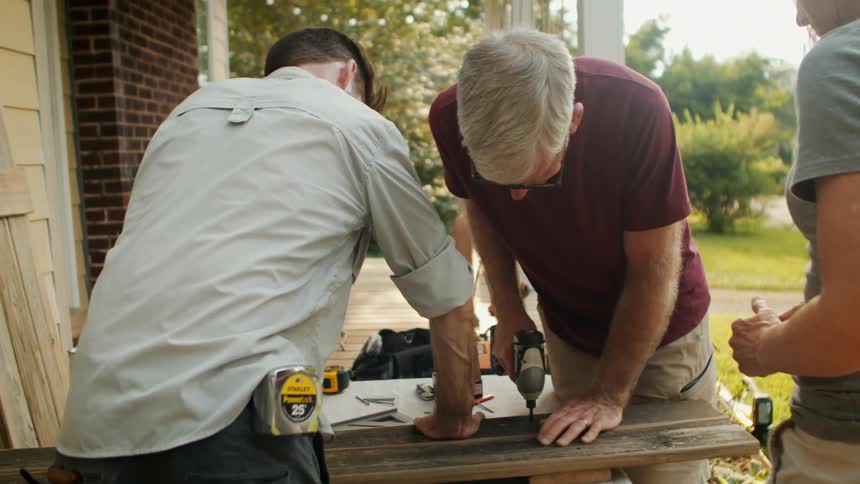 Two men drilling a wood