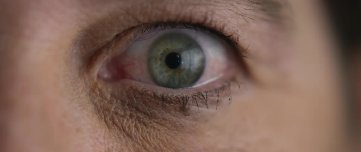 Close up of a persons eye opening